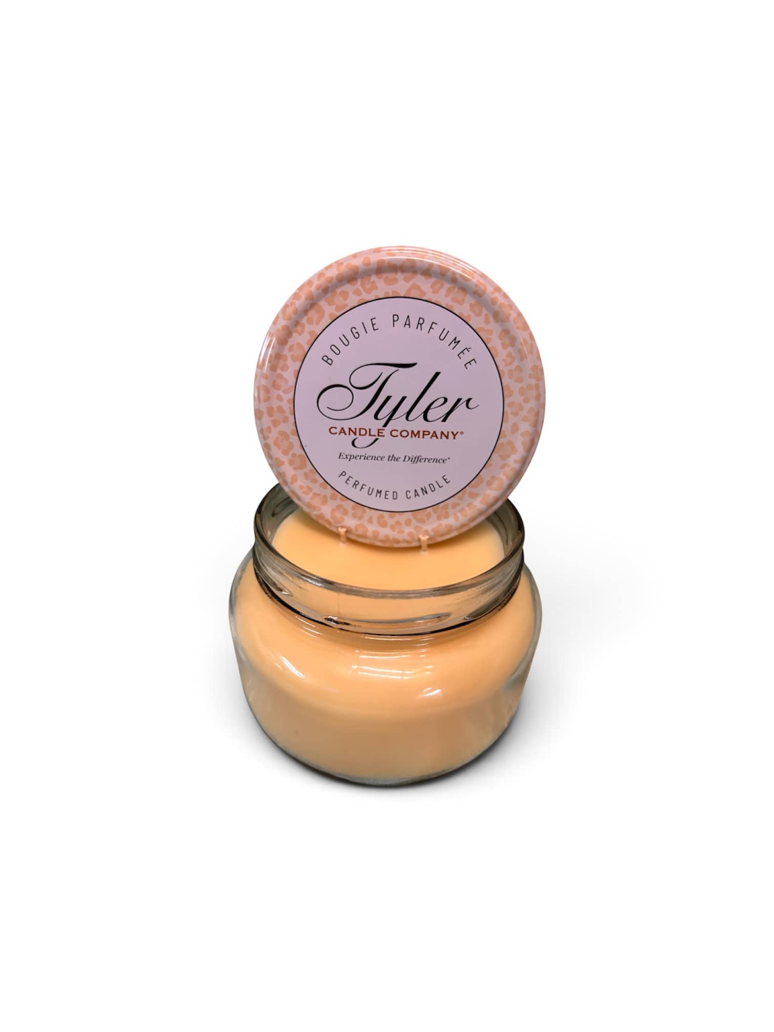 Jar candle with a round lid labeled Tyler Candle Company