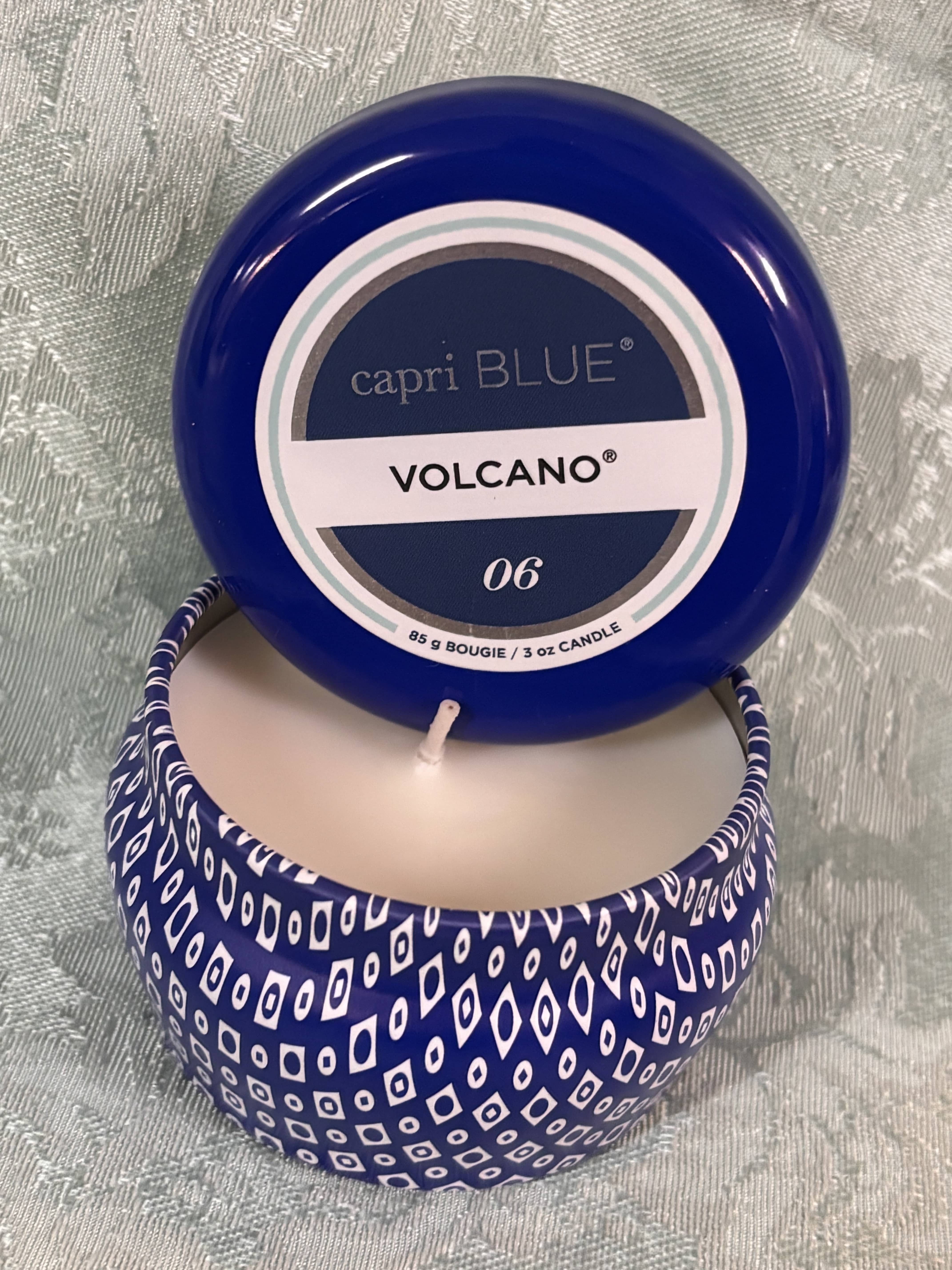 Blue Capri Blue Volcano candle in a patterned tin container