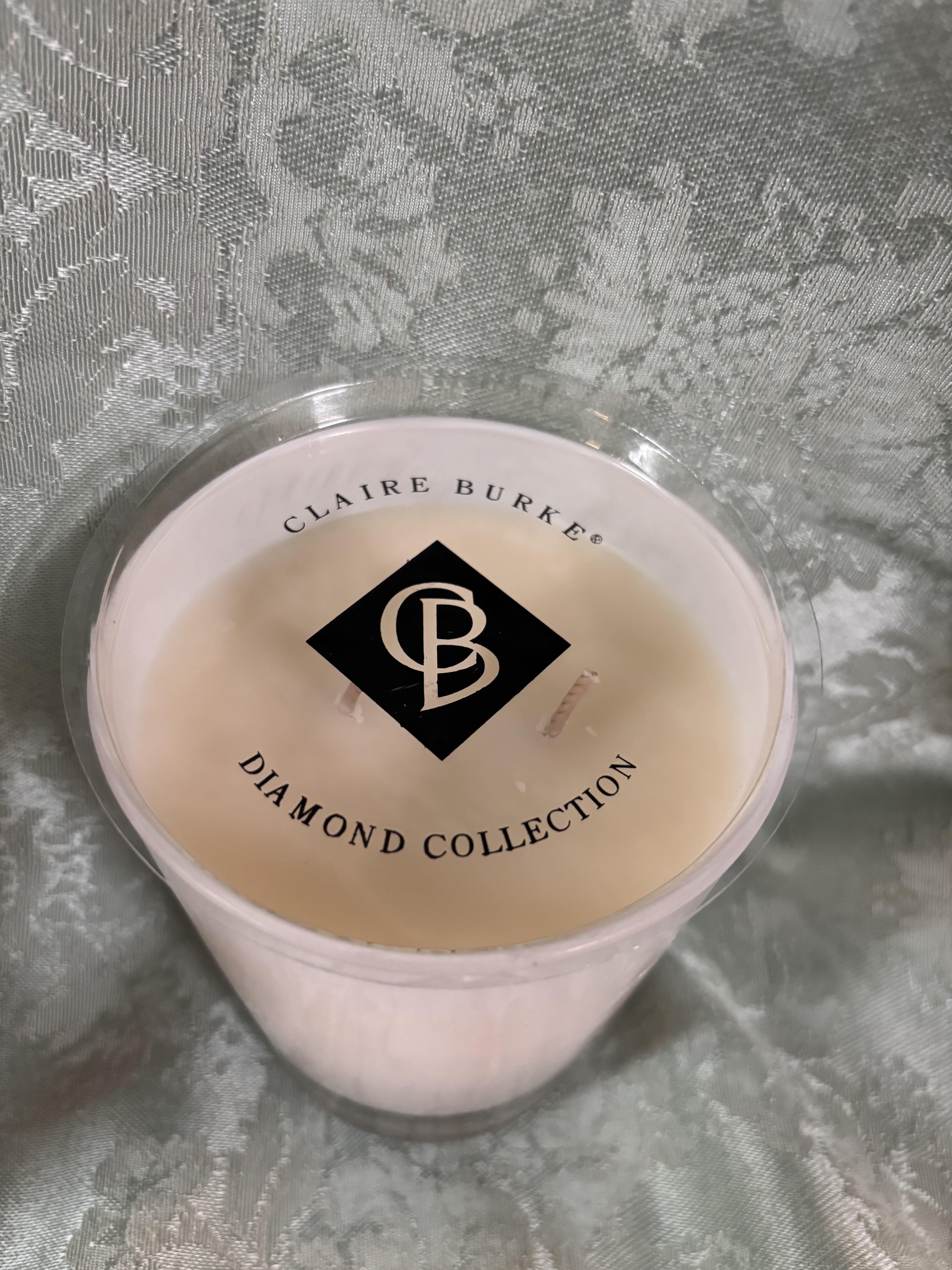 Pink candle in a clear plastic cup with a labeled lid