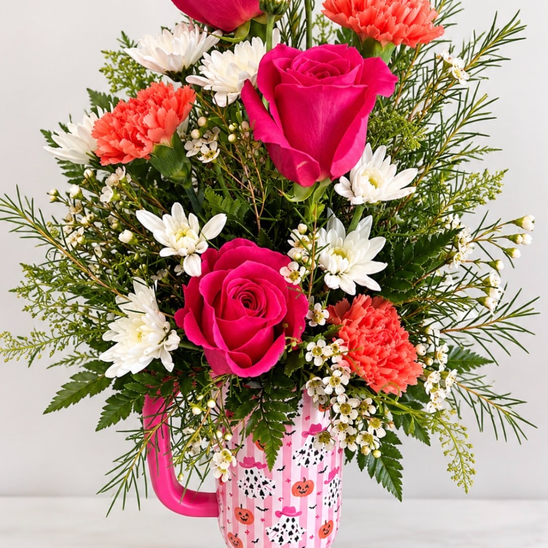 Pink roses and white daisies in a Halloween mug