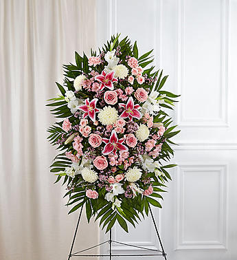 Deepest Sympathies Standing Spray-Pink &amp; White - Product ID: 91285   This Sympathy Standing Spray, in shades of peach, orange and white, is a beautiful symbol of your sympathy and support. Pink roses, stargazer lilies, spray roses, white carnations and more An appropriate gift for family, friends and business associates to send directly to the funeral home Our florists use only the freshest flowers available so colors and varieties may vary Large measures approximately 54"H x 42"L without easel Medium measures approximately 46"H x 38"L without easel Small measures approximately 42"H x 32"L without easel