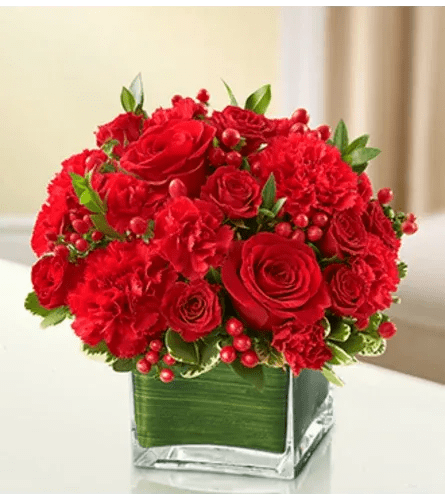 All My Love - All Red - Product ID: 95396  The symbol of courage and strength, an all-red bouquet conveys your sympathies with striking beauty. Our florists fill a stylish cube vase with roses, spray roses, Gerberas, carnations and more to send a fitting tribute during times of sorrow. Elegant arrangement of red roses, spray roses, Gerbera daisies, carnations, mini carnations and hypericum, accented with variegated pittosporum and myrtle Artistically designed by our florists in a classic clear glass cube vase lined with a Ti leaf ribbon; vase measures 5"H x 5"D Appropriate for the service or for sending to the home or office of friends and family members Large arrangement measures approximately 11"H x 11"L Medium arrangement measures approximately 10"H x 10"L Small arrangement measures approximately 9"H x 9"L Our florists hand-design each arrangement, so colors, varieties, and container may vary due to local availability