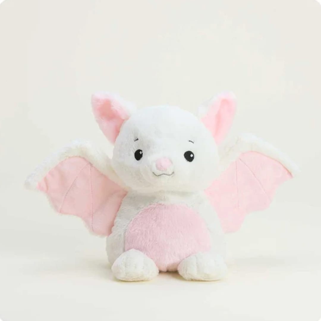 Plush white bat toy with pink wings and belly on a plain background