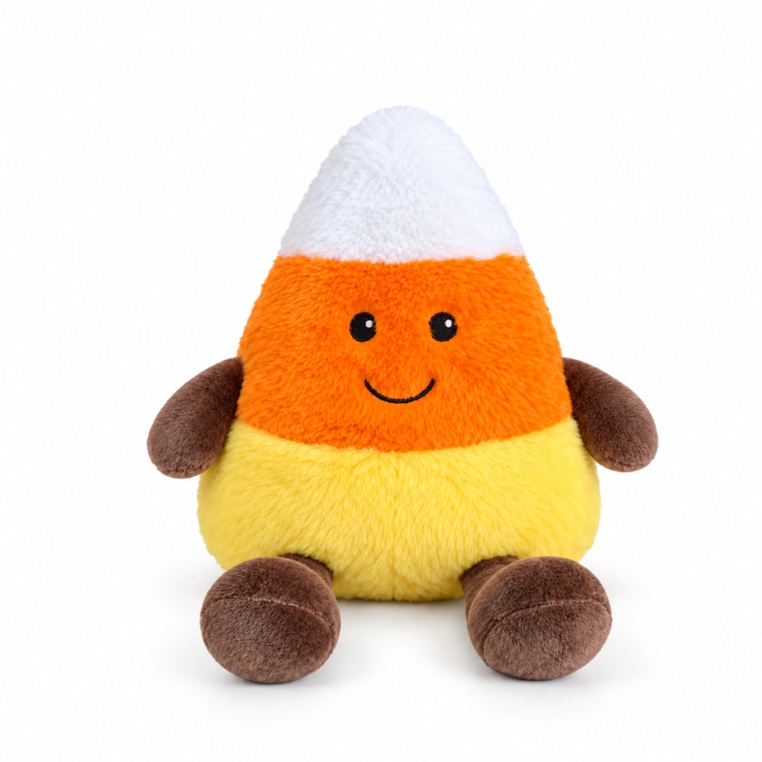 Candy corn plush toy with a smiling face on a white background
