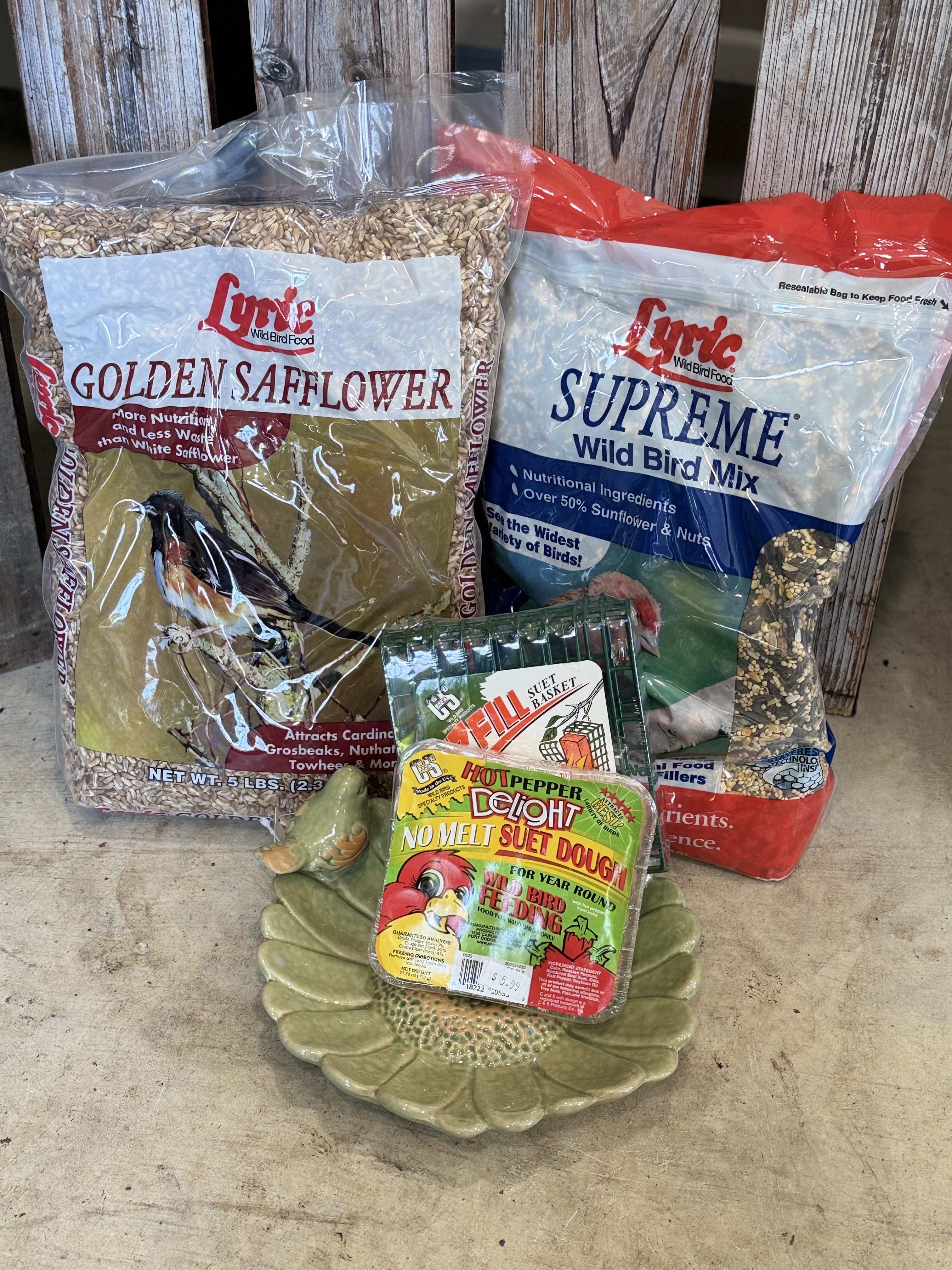 Bird food bags and suet cakes arranged on the floor