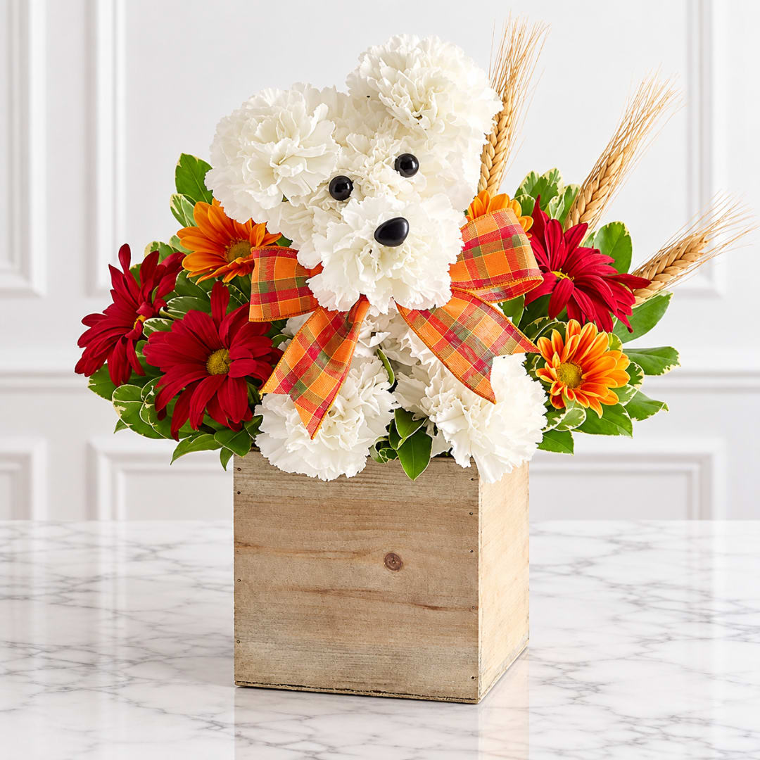 White teddy bear floral arrangement in a wooden box with red and orange flowers