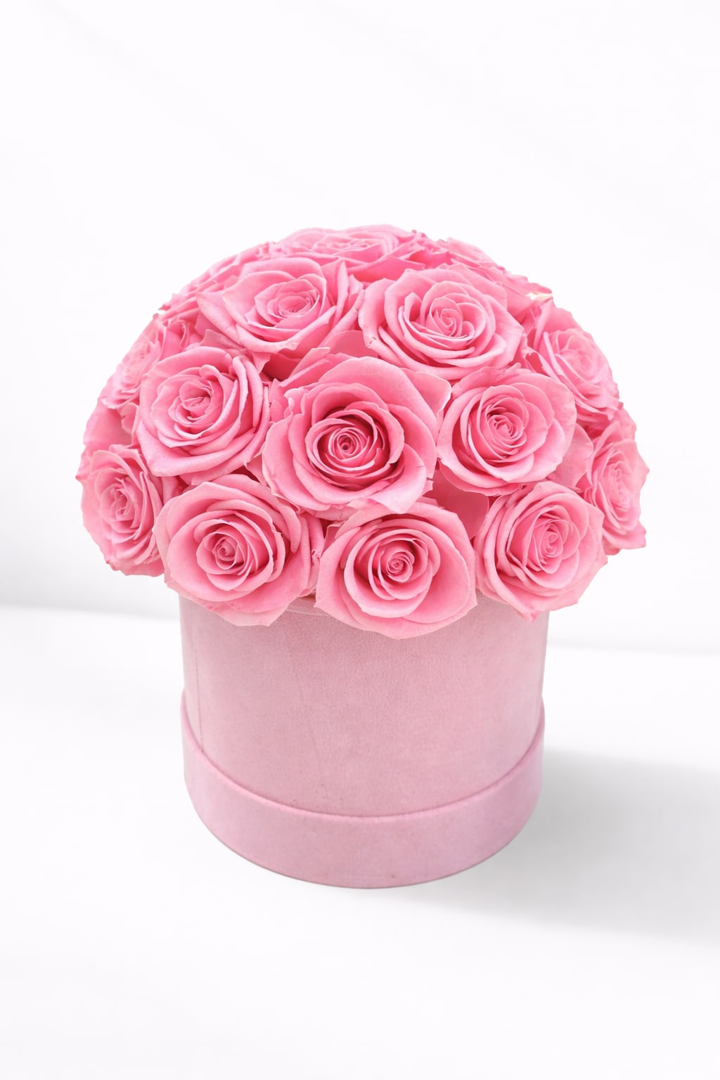 Pink roses arranged in a round pink box