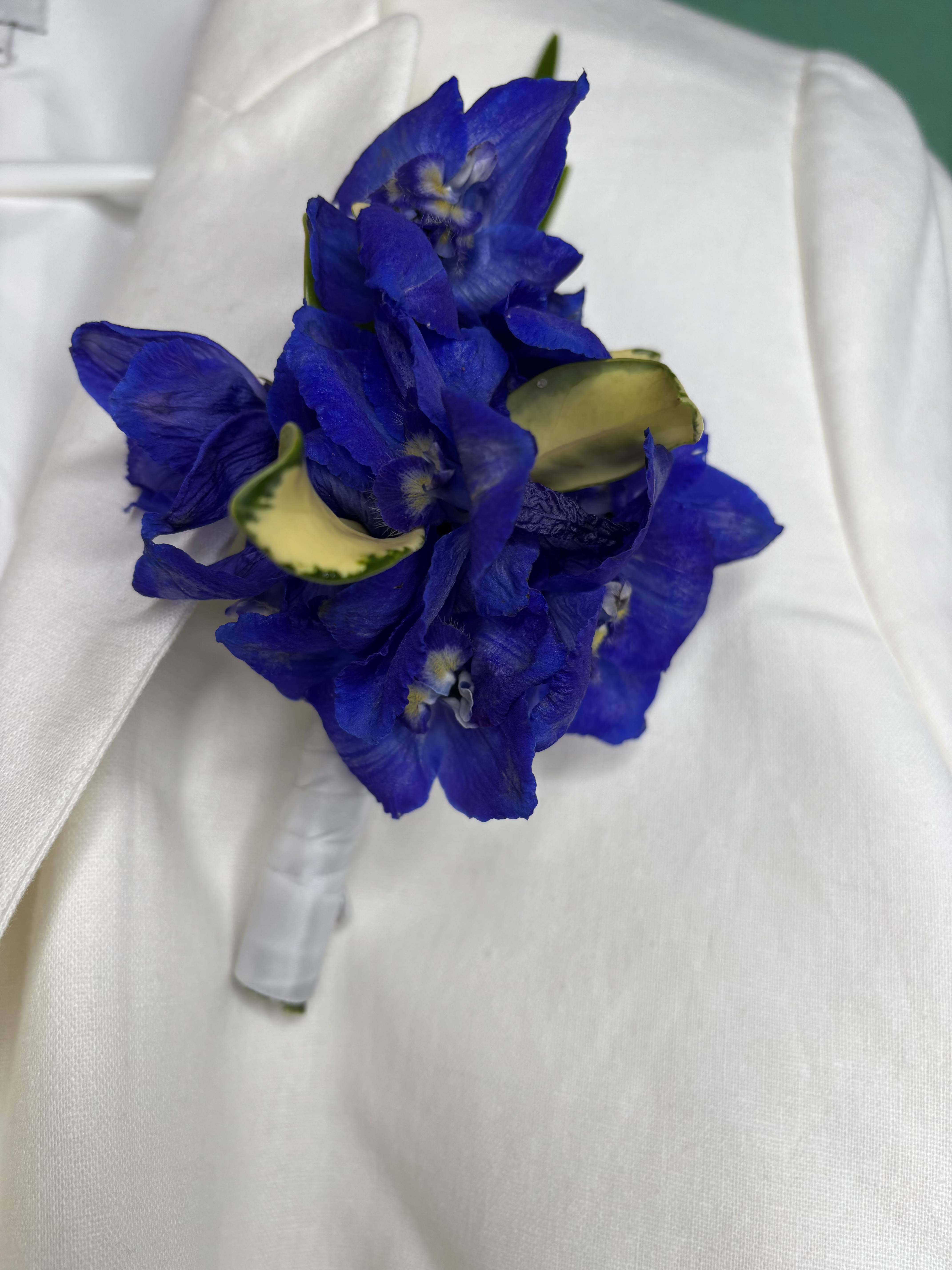 Blue flower boutonniere with white ribbon wrap