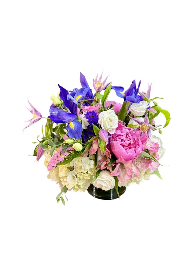 Mixed bouquet of purple, pink, and white flowers in a black vase