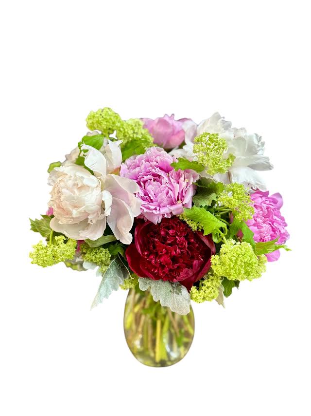 Bouquet of pink, white, and red flowers in a glass vase