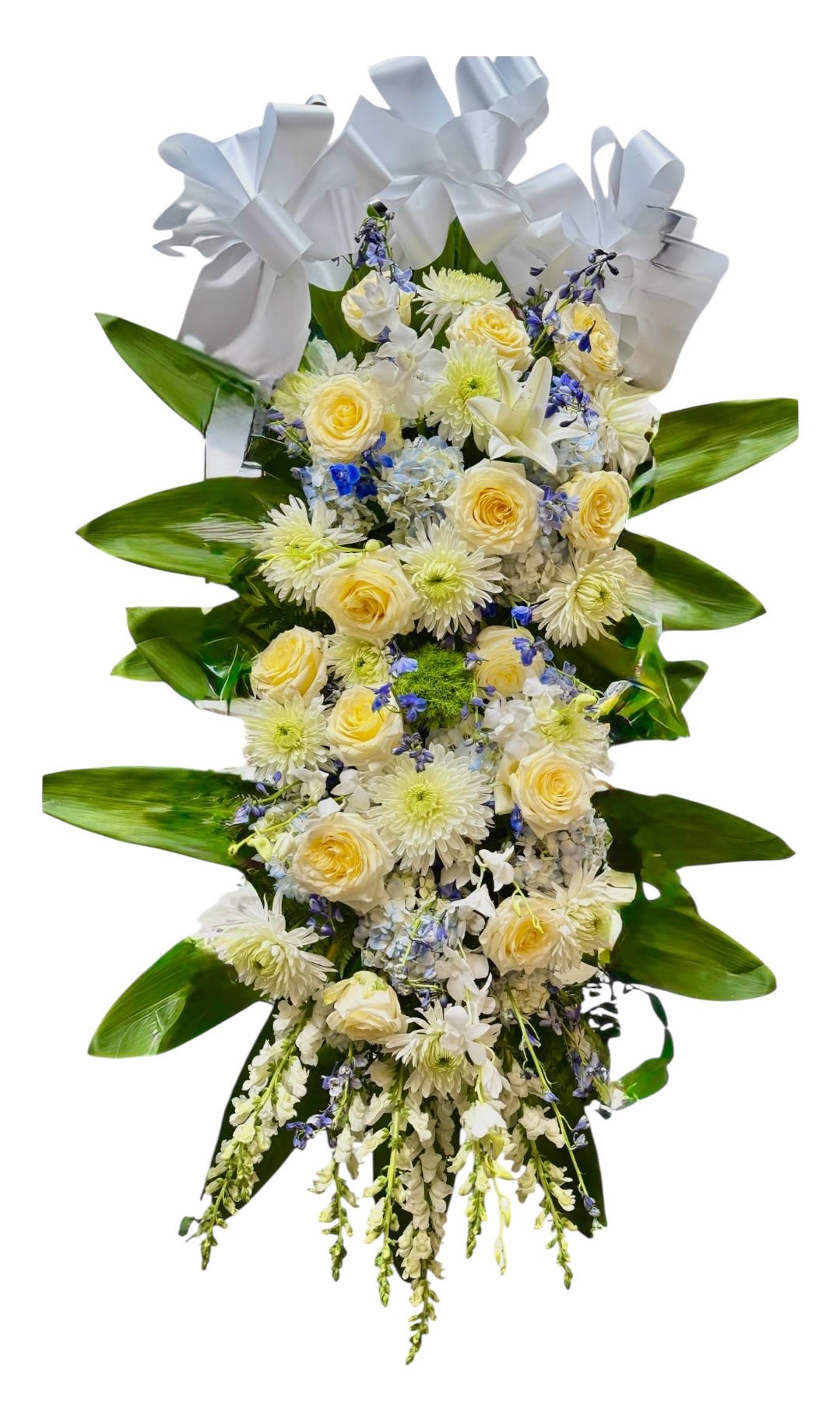 Tall floral standing spray with white and pale yellow blooms and a white bow
