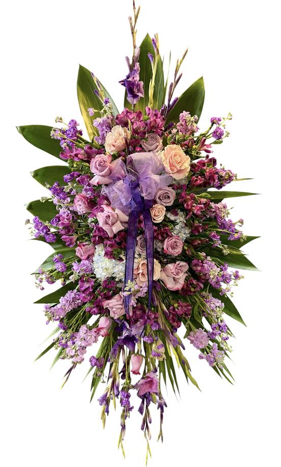 Large purple and pink floral spray with ribbon accents