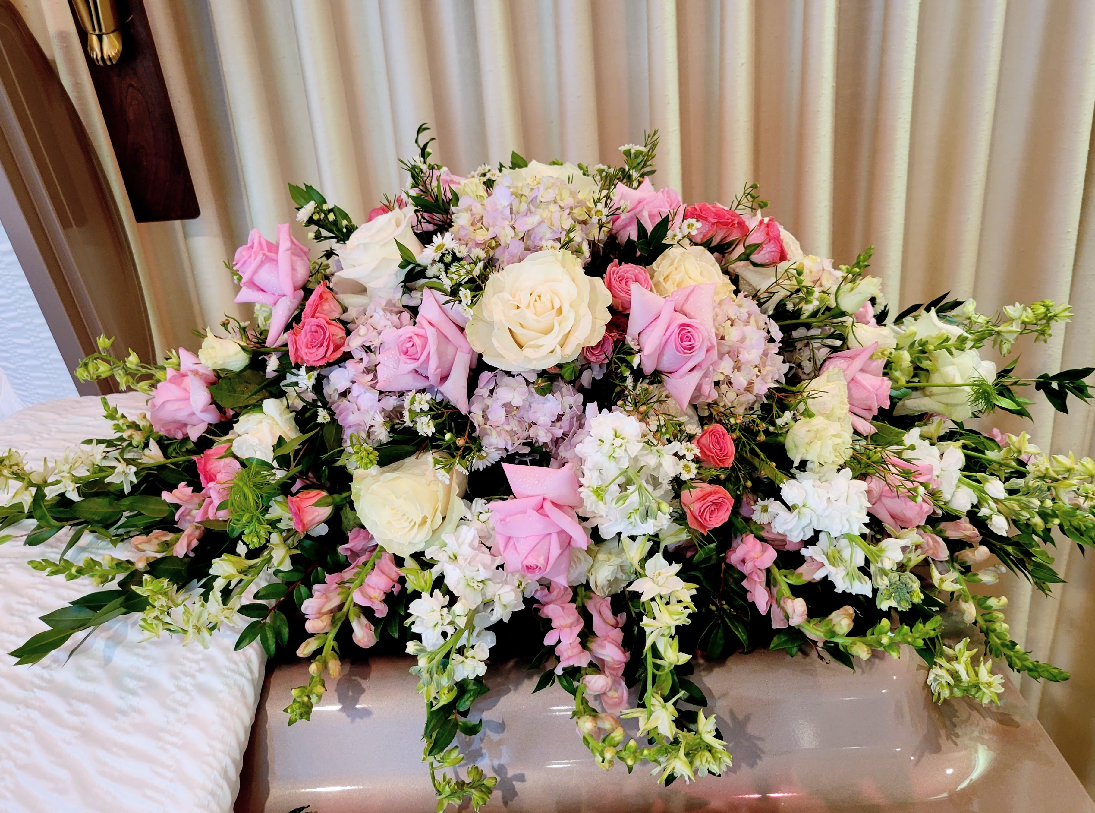 Large pink and white floral arrangement with roses and mixed blooms