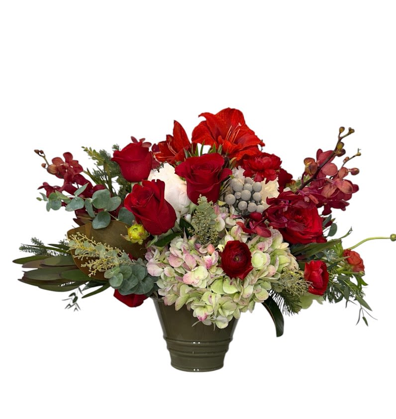 Red roses and mixed flowers arranged in a dark vase
