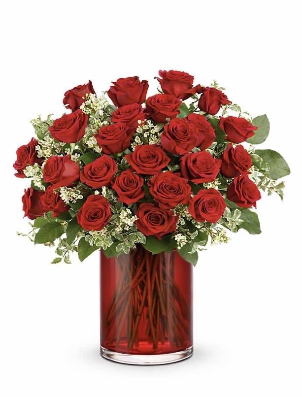 Red roses arranged in a red glass vase