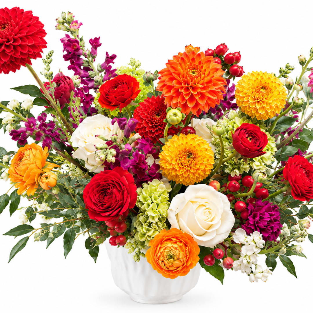 Colorful mixed bouquet in a white vase with roses and dahlias