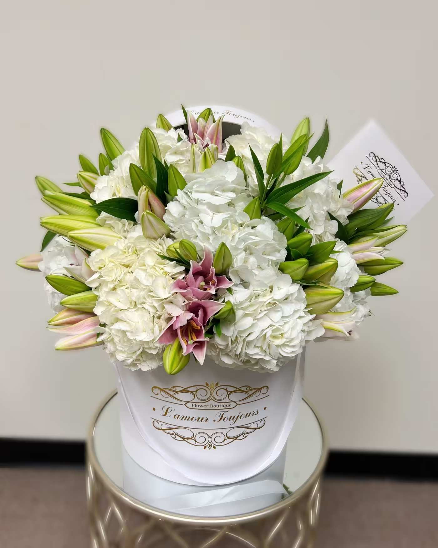 White hydrangea and lily bouquet in a white wrap