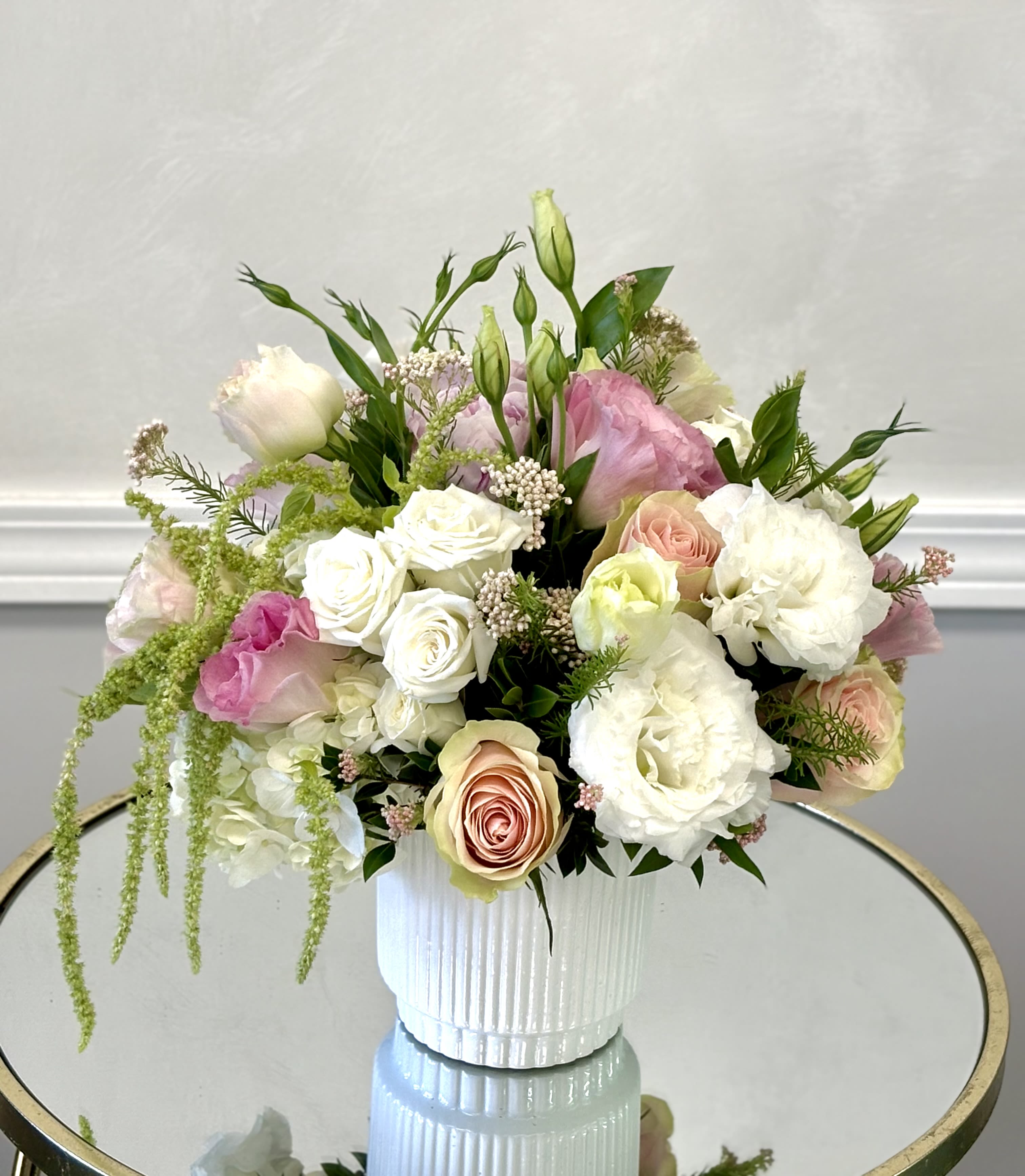 Romantic Garden Glow By VLM Flowers - Blush tones and creamy whites blend beautifully with lush greenery, creating a warm and inviting floral design with a natural garden style.