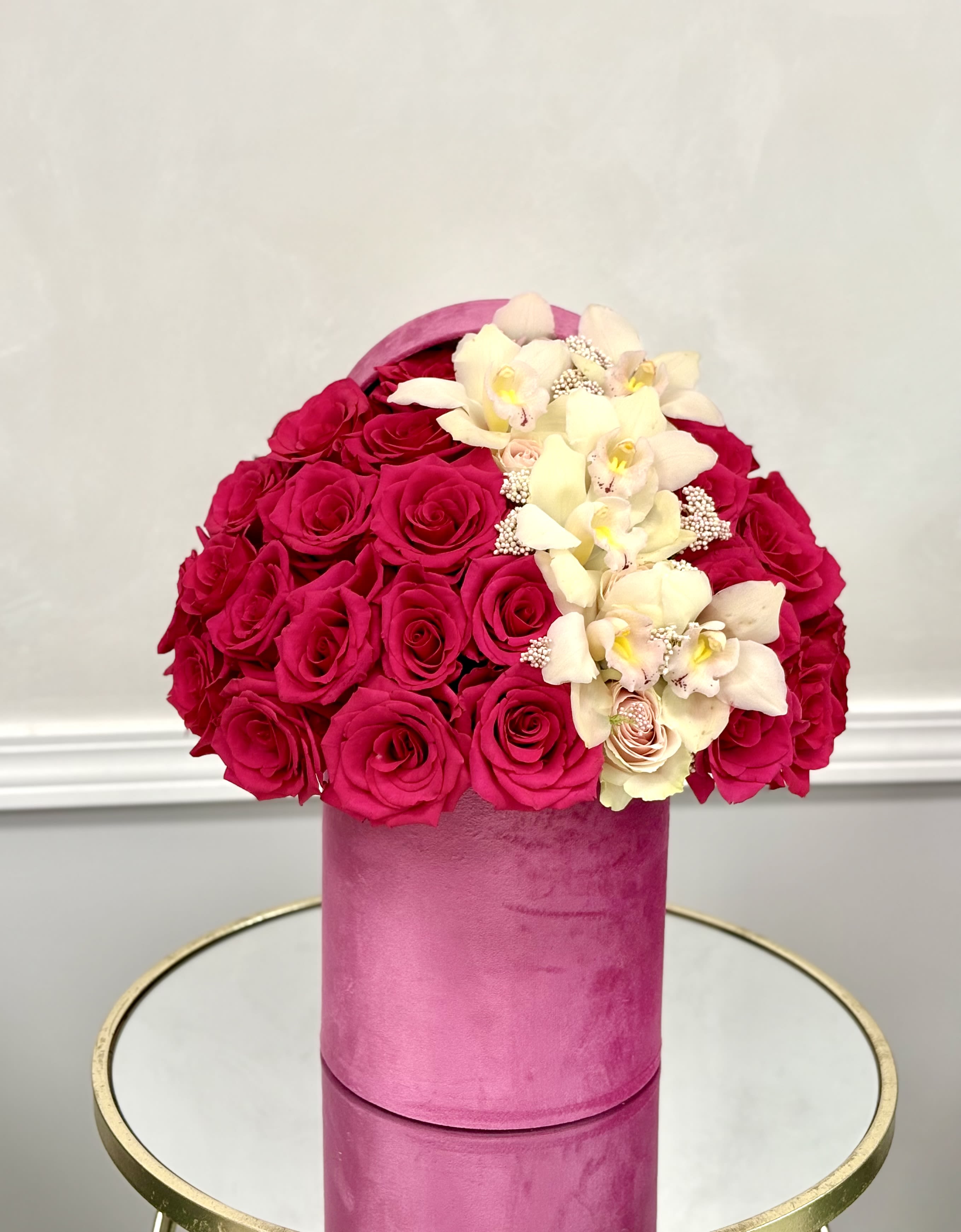 Love in Velvet By VLM Flowers - A romantic mix of rich hot pink roses and soft orchids arranged in a blush velvet box, perfect for expressing deep love and admiration.