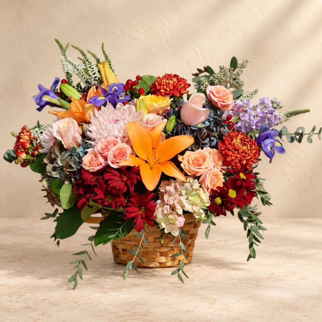 Colorful mixed flower arrangement in a woven basket
