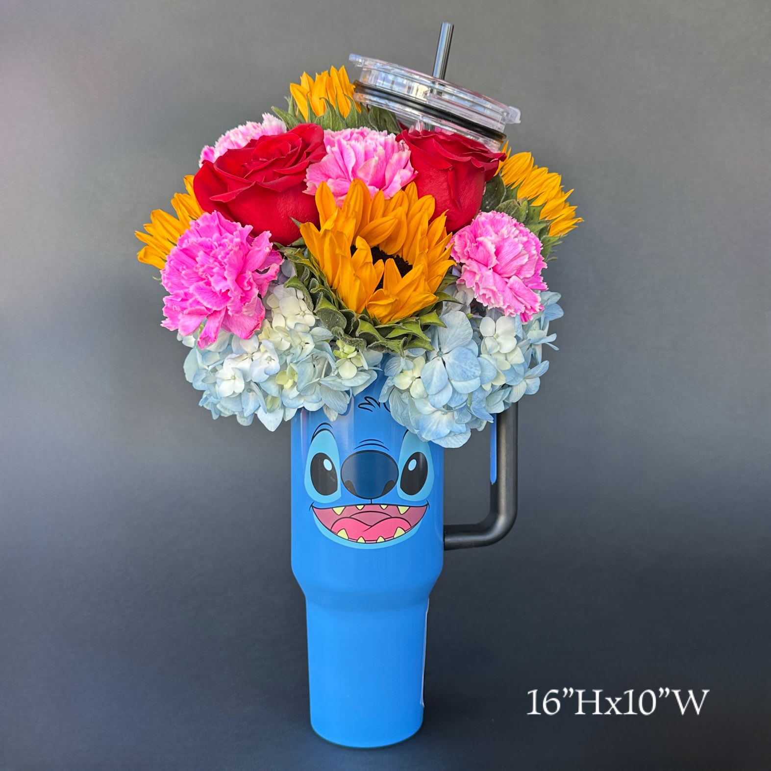 Colorful flower arrangement in a blue character tumbler with a lid