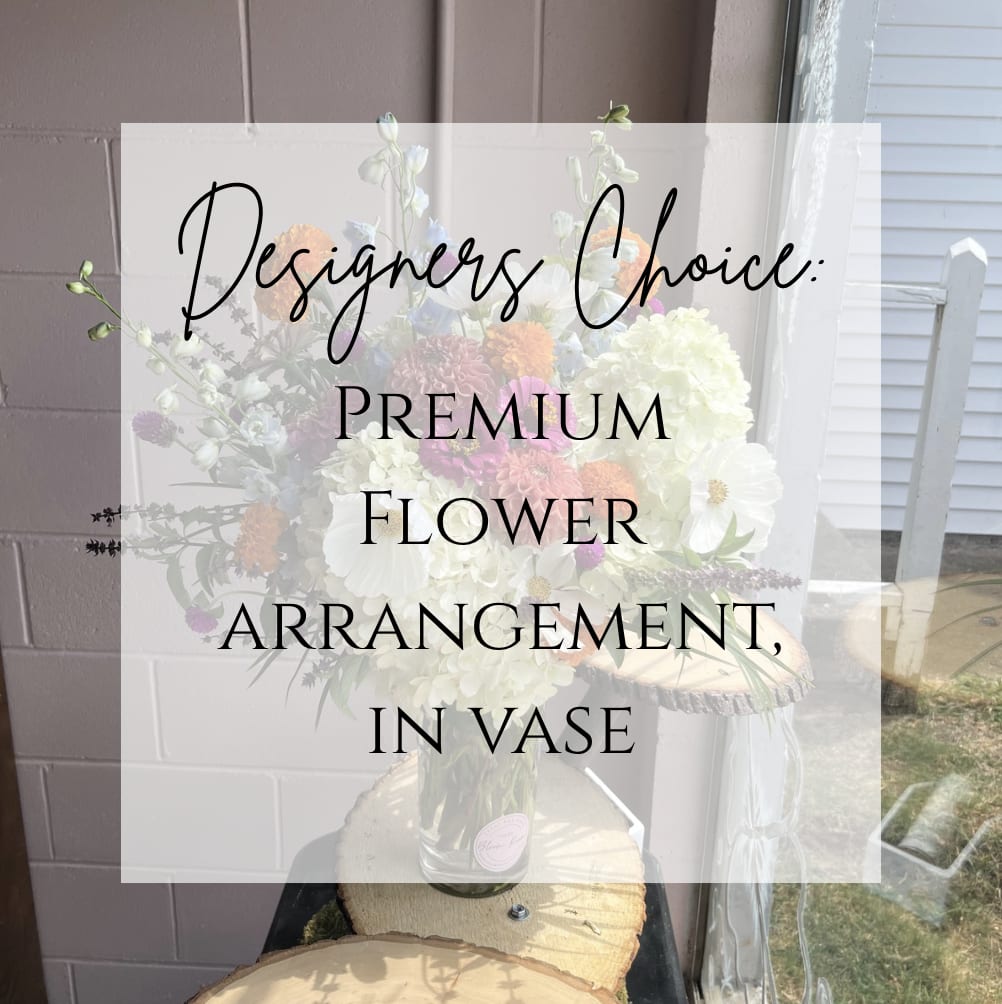 Mixed flower arrangement in a clear vase with white and pastel blooms