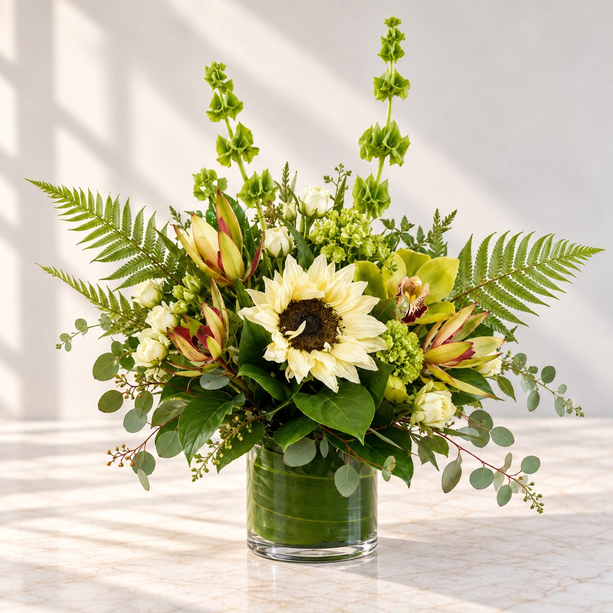 Sunflower and white rose arrangement in a clear glass vase