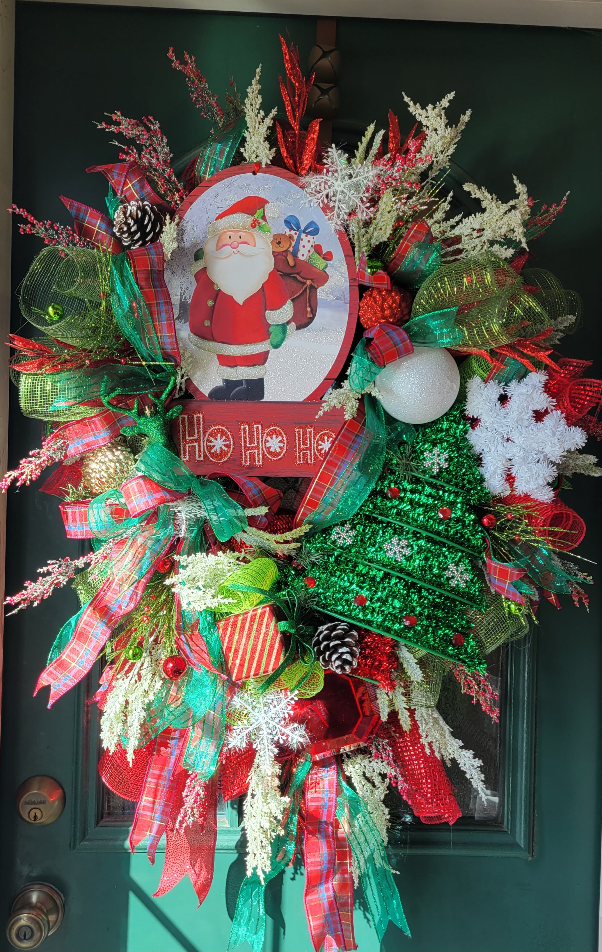 Christmas wreath with Santa sign, ribbons, pinecones, and ornaments