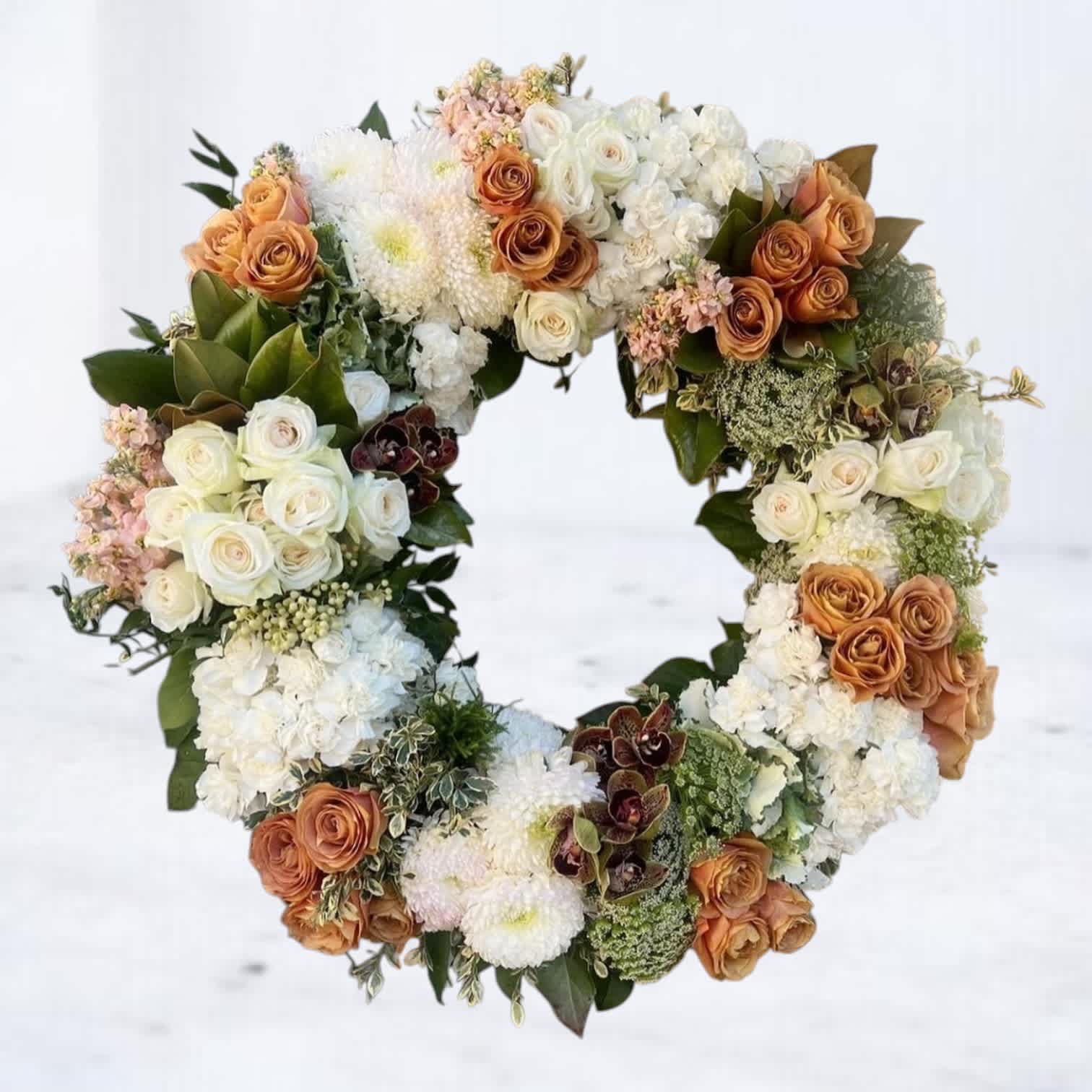 Heart-shaped floral wreath with white and peach roses