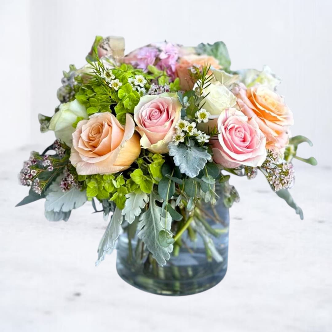 Bouquet of pastel roses in a glass vase