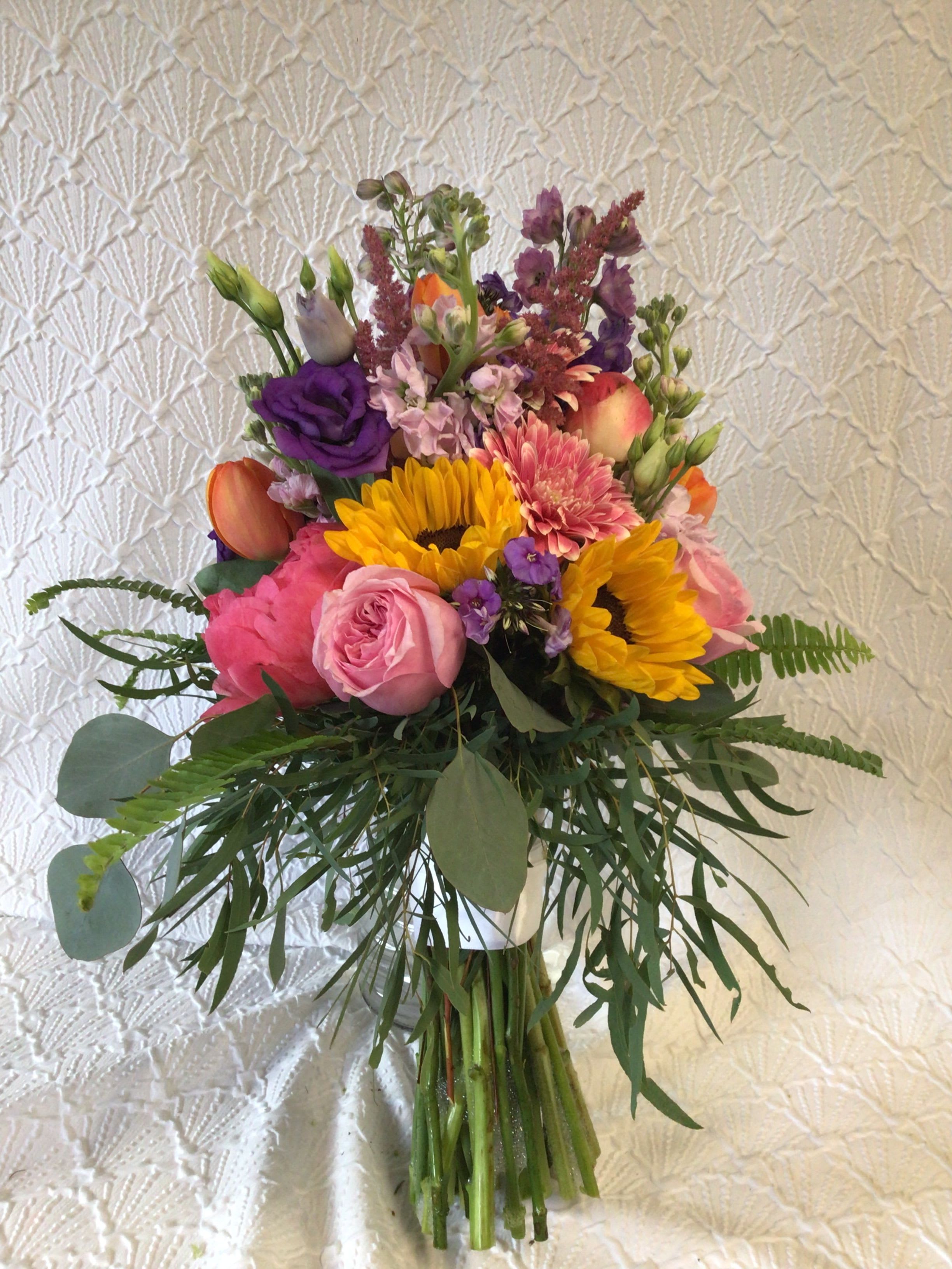 Garden Handheld Bouquet - This handheld bouquet of a stunning mix of flowers is bound together with a ribbon. All special occasion bouquets can be modified with color and flower preferences to match your own personal, unique preferences. 