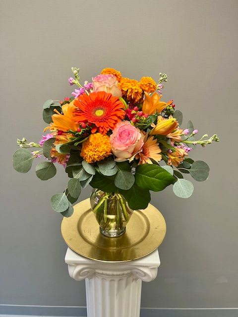 Magic Is In The Air - Celebrate any occasion with this lively bouquet. The arrangement includes roses, carnations, and other seasonal blooms. 