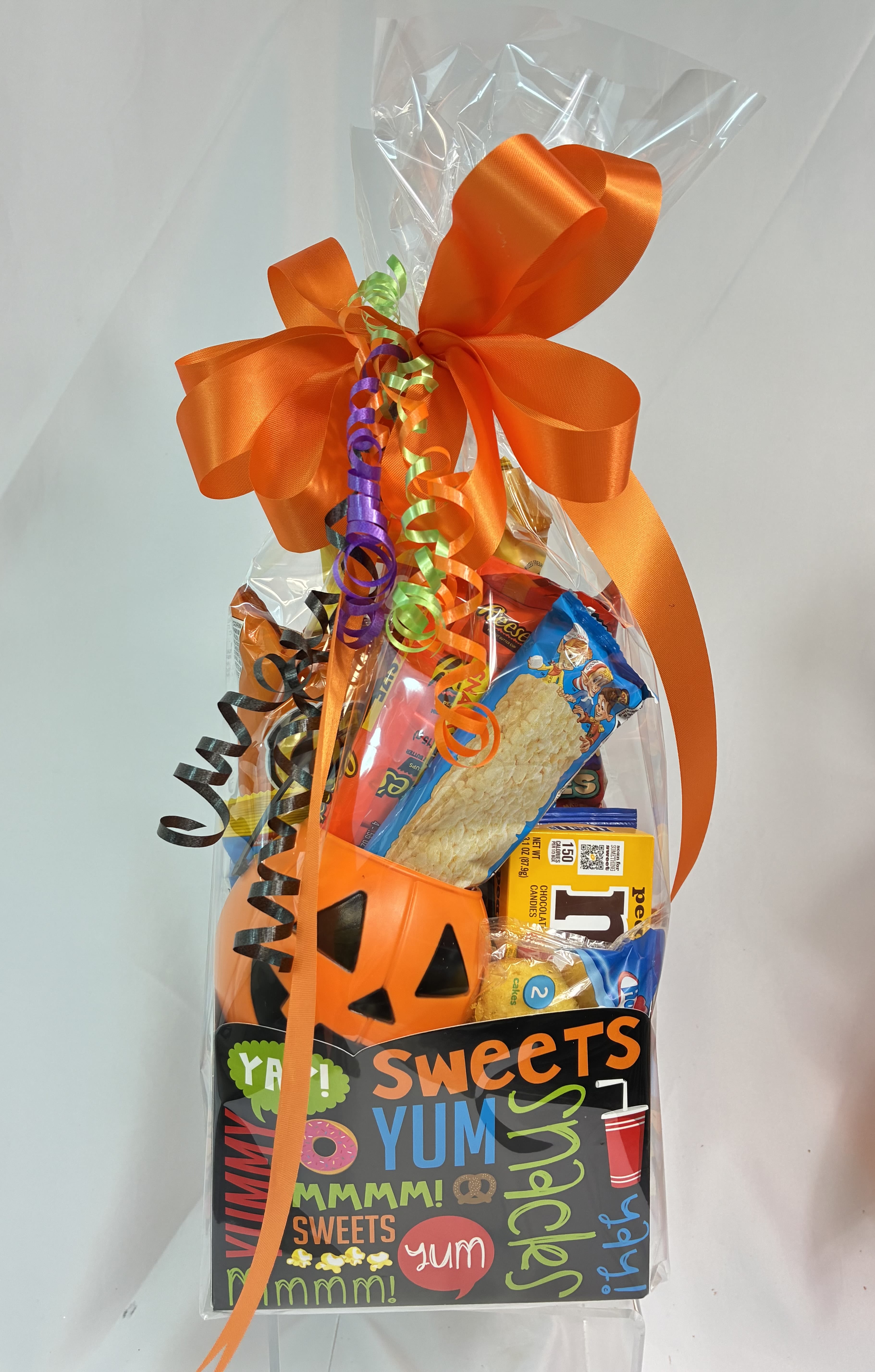 Halloween candy gift bag with an orange bow and pumpkin bucket