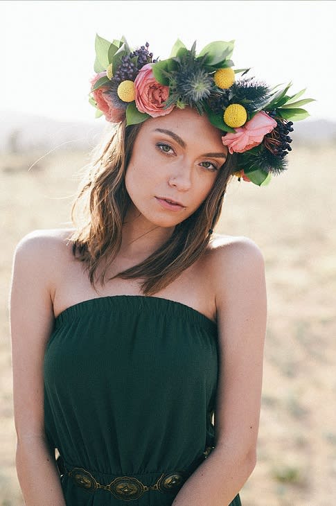 Woman wearing a floral crown with pink and yellow flowers