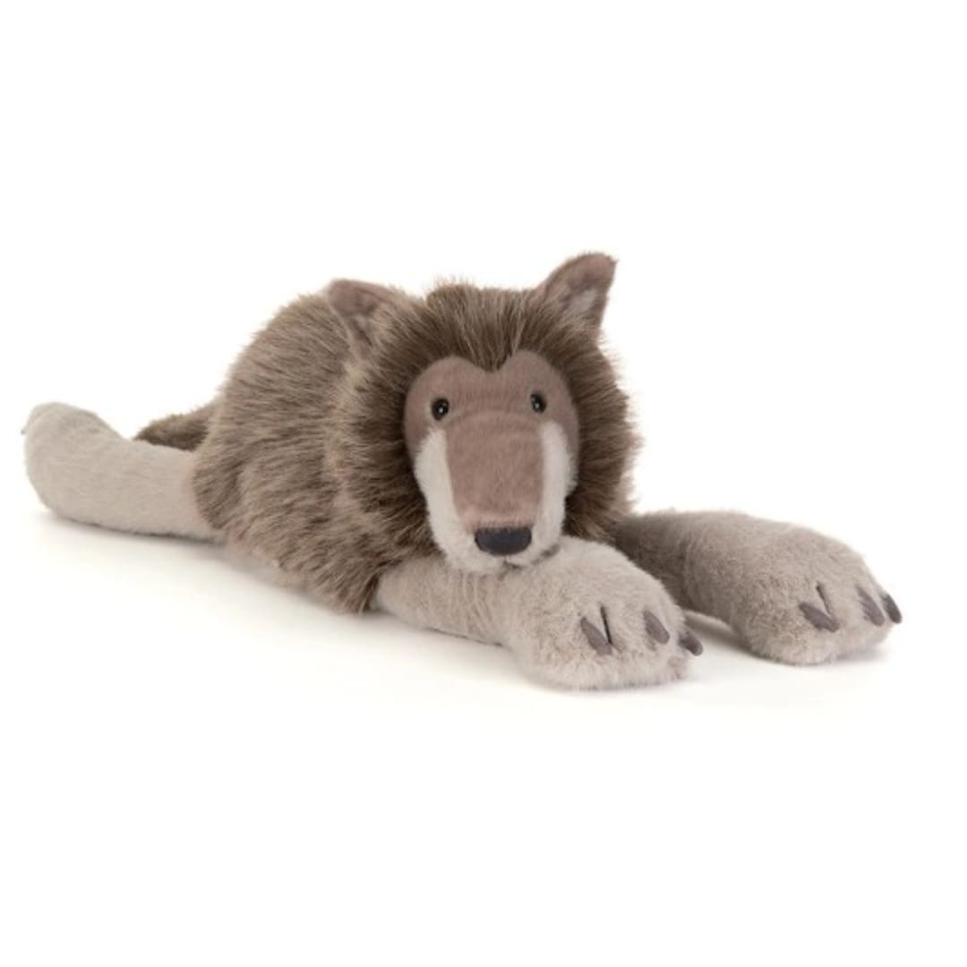 Plush lion toy lying down on a white background