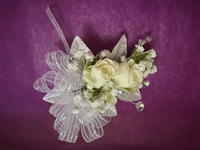 White rose corsage with sheer ribbon and small white accents