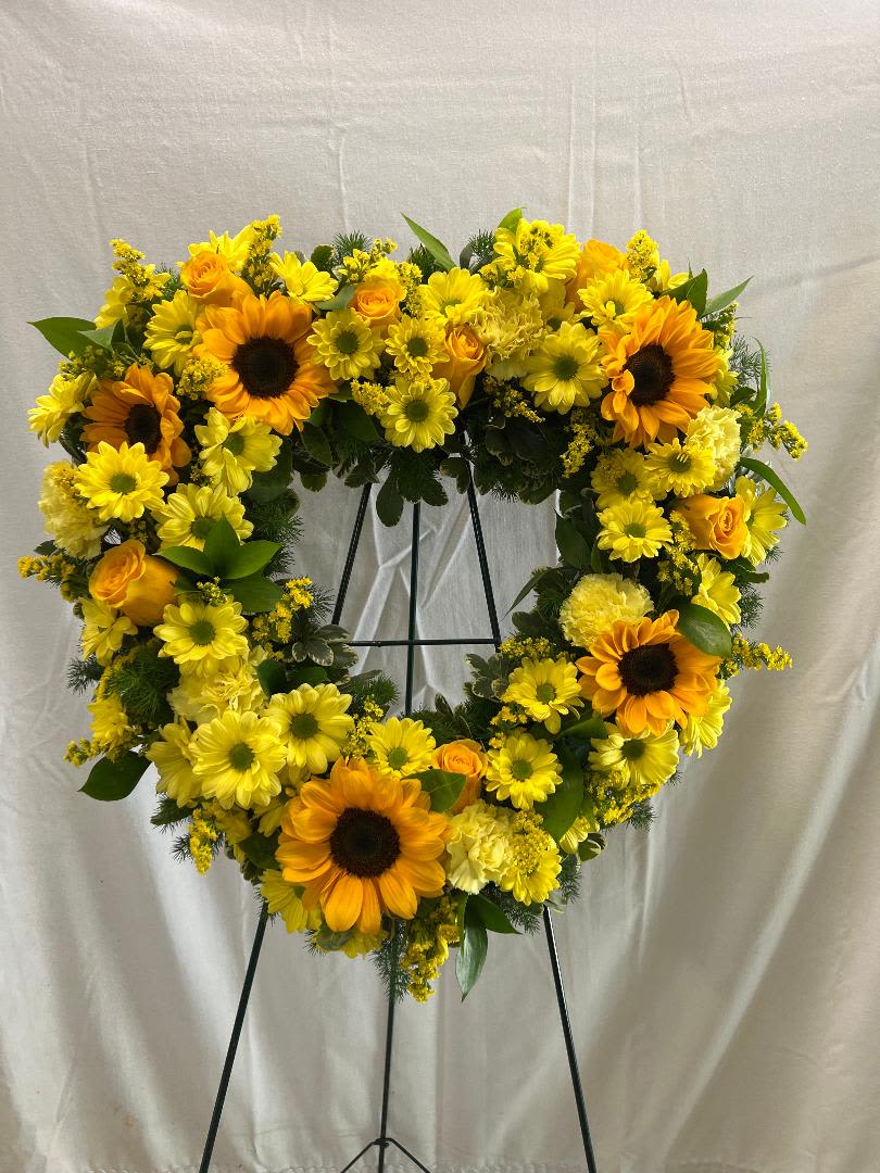 GOLDEN LOVE - 18" OPEN HEART, FILLED WITH SUNFLOWERS, YELLOW DAISIES, YELLOW ROSES, FILLER AND CARNATIONS.