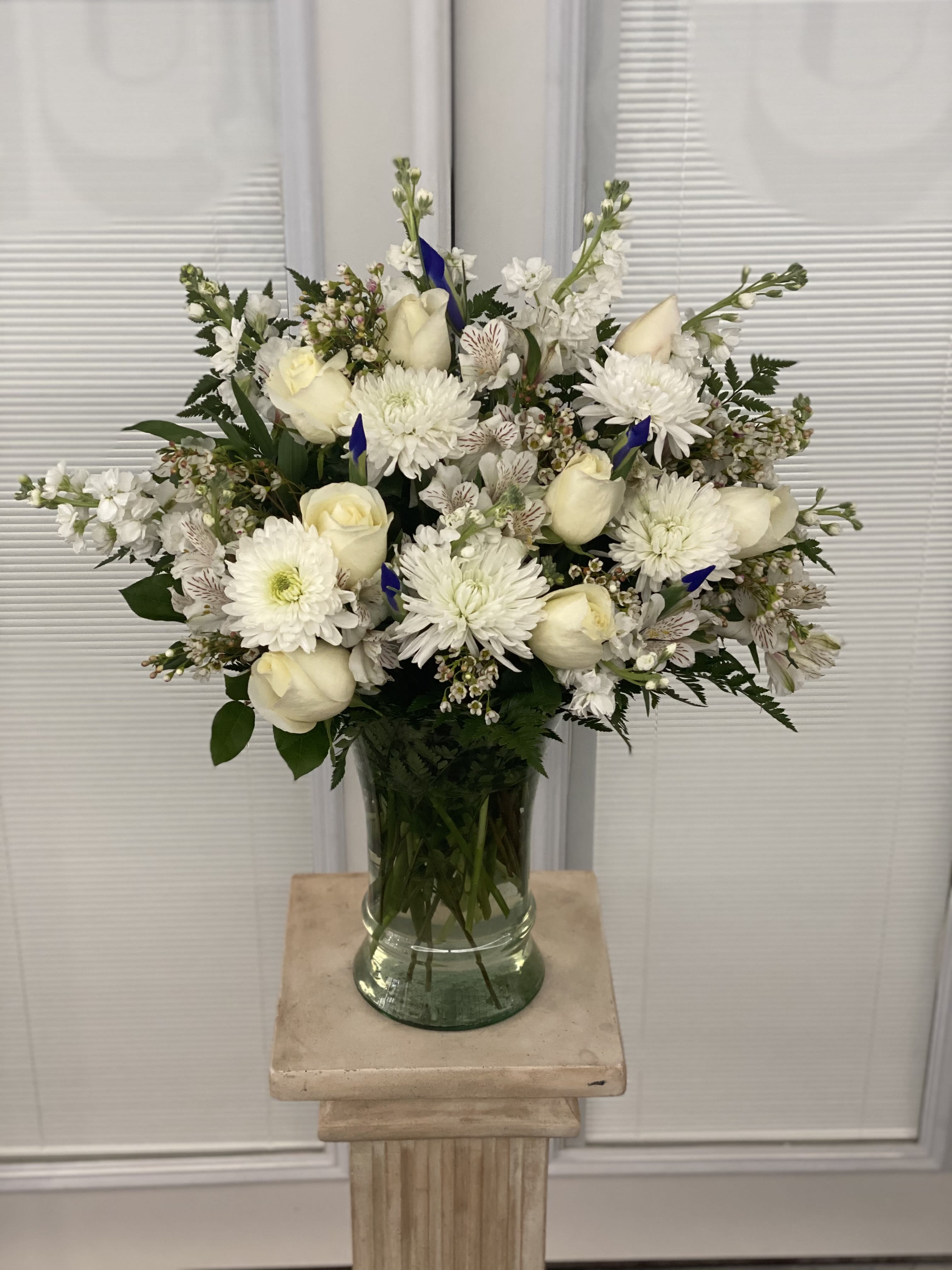 Sincerest Sorrow - Blue and White - Beautiful in blue and white, our abundant sympathy arrangement makes a fitting remembrance during difficult times.