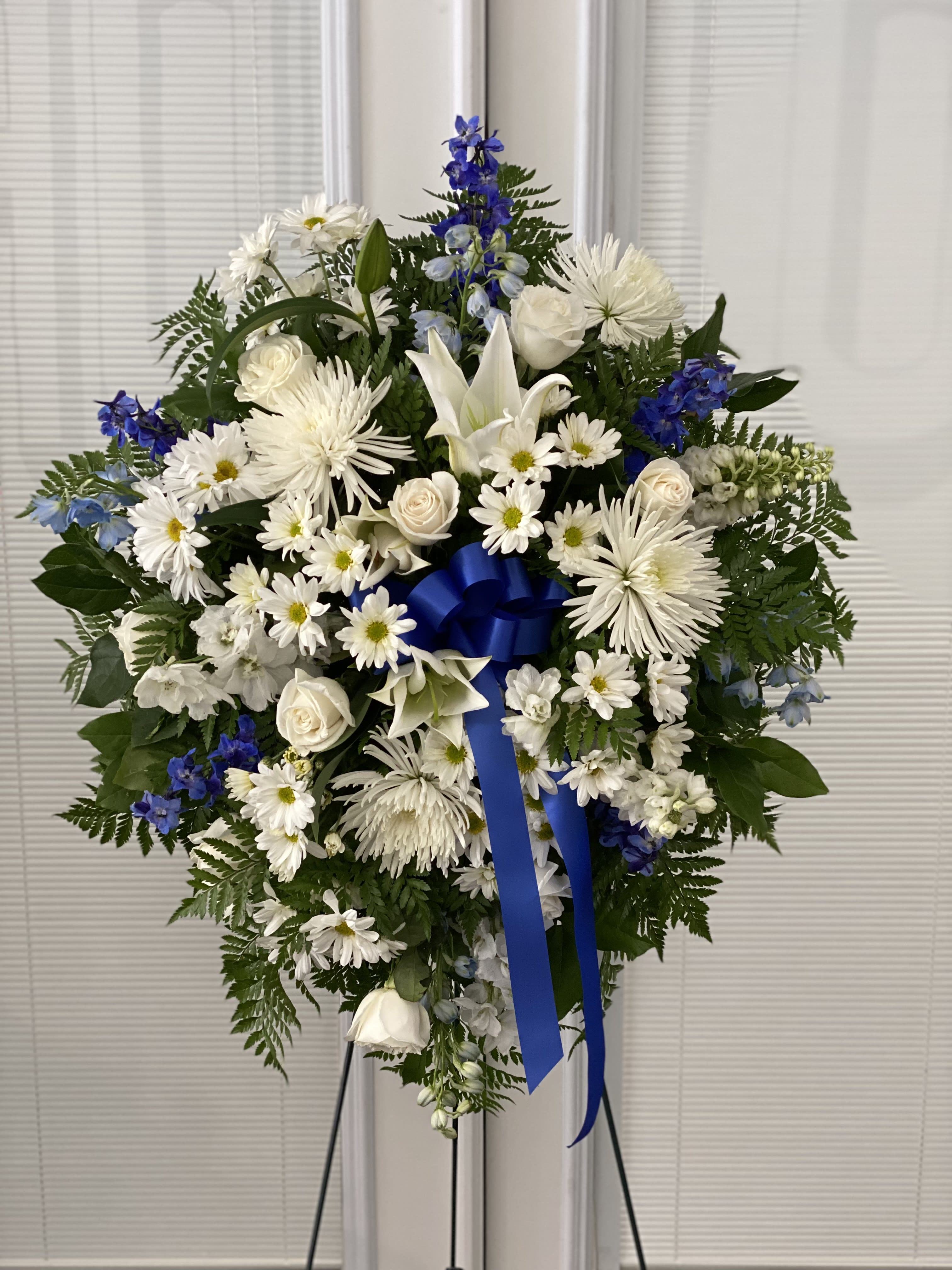 Deepest Sympathies Blue &amp; White Standing Spray - Show all the love and compassion you have in your heart during times of loss with our beautiful blue and white standing spray. Gathered fresh with blue and white blooms, this expertly crafted arrangement is a tasteful and touching expression of your care and concern. 