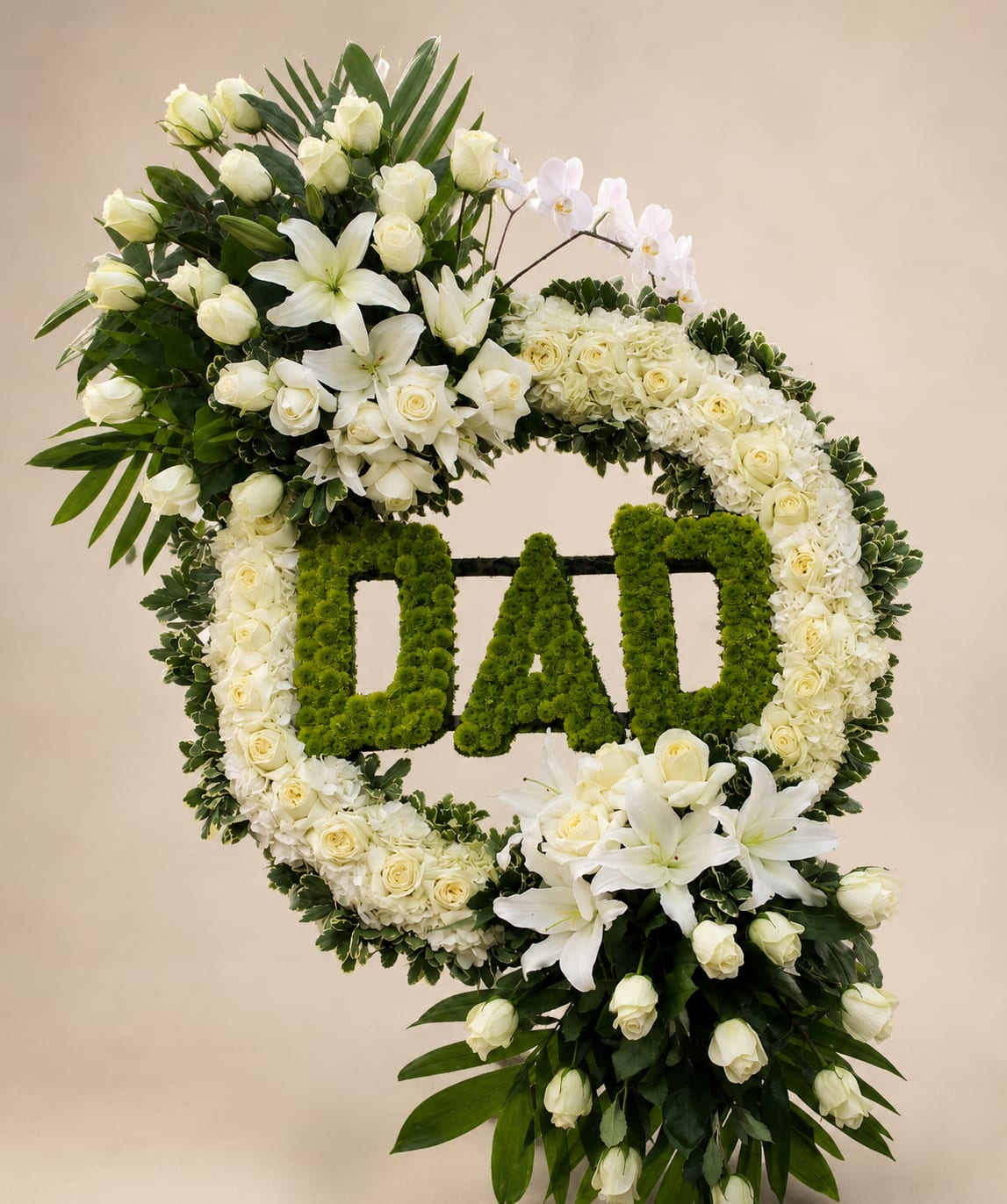 Dad's Eternal Garden - A dignified memorial wreath crafted in white and green for a father - a standing sympathy tribute designed to honor Dad at a funeral, remembrance service, or Father's Day memorial. The wreath's bold green "DAD" lettering is set against a dense ring of white blooms, creating a clear, heartfelt message that will read from a distance and comfort the people gathered. Da
