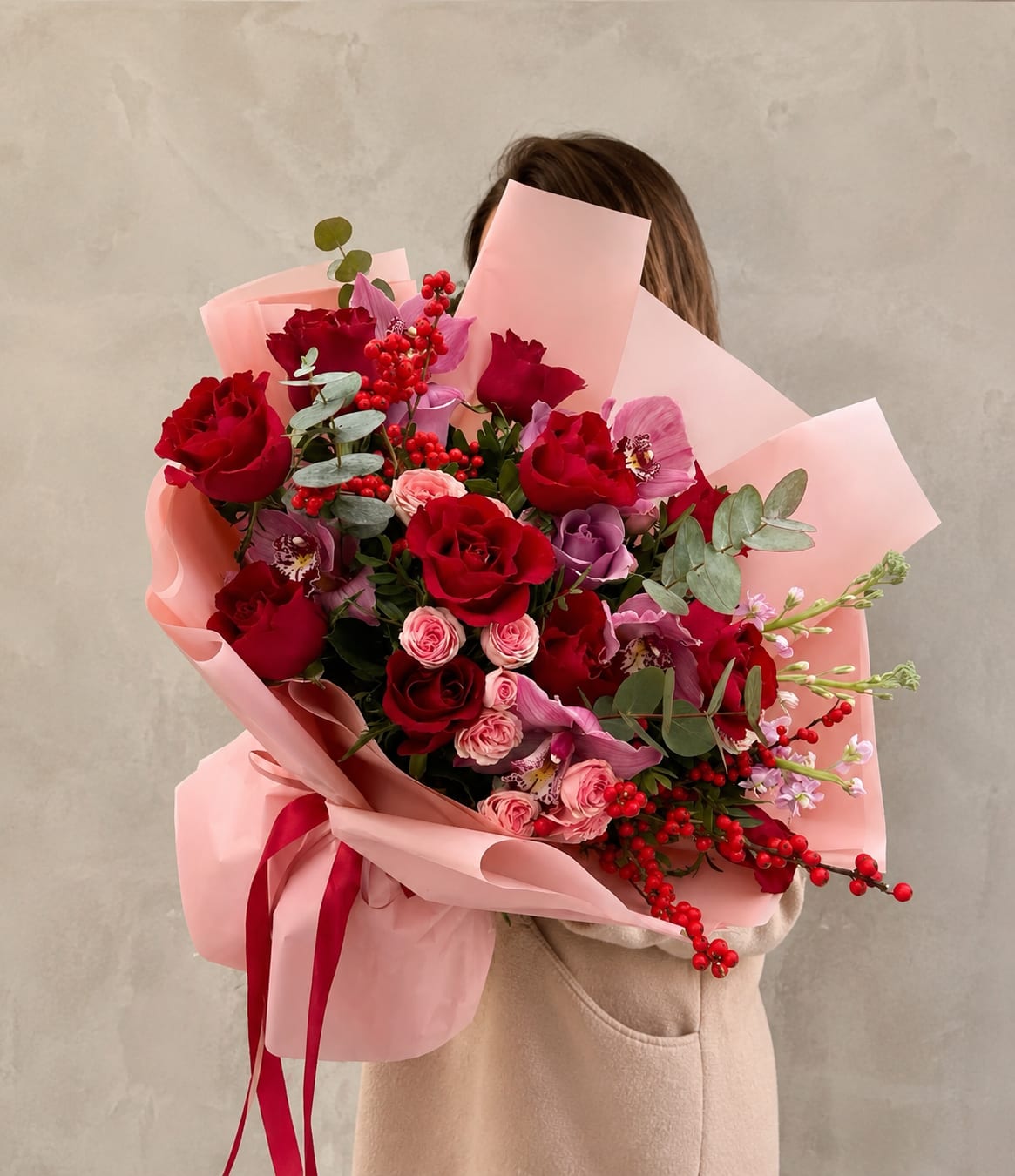 MAISON ROSE - Lush deep red roses paired with soft pink spray roses give this hand-tied flower arrangement an instantly romantic, celebratory feel-perfect as an anniversary bouquet, a birthday surprise, or a "just because I adore you" gift. Purple Flowers blooms peek through for a modern contrast, while a pale eucalyptus-like foliage add texture and depth so the recipient feels truly seen.