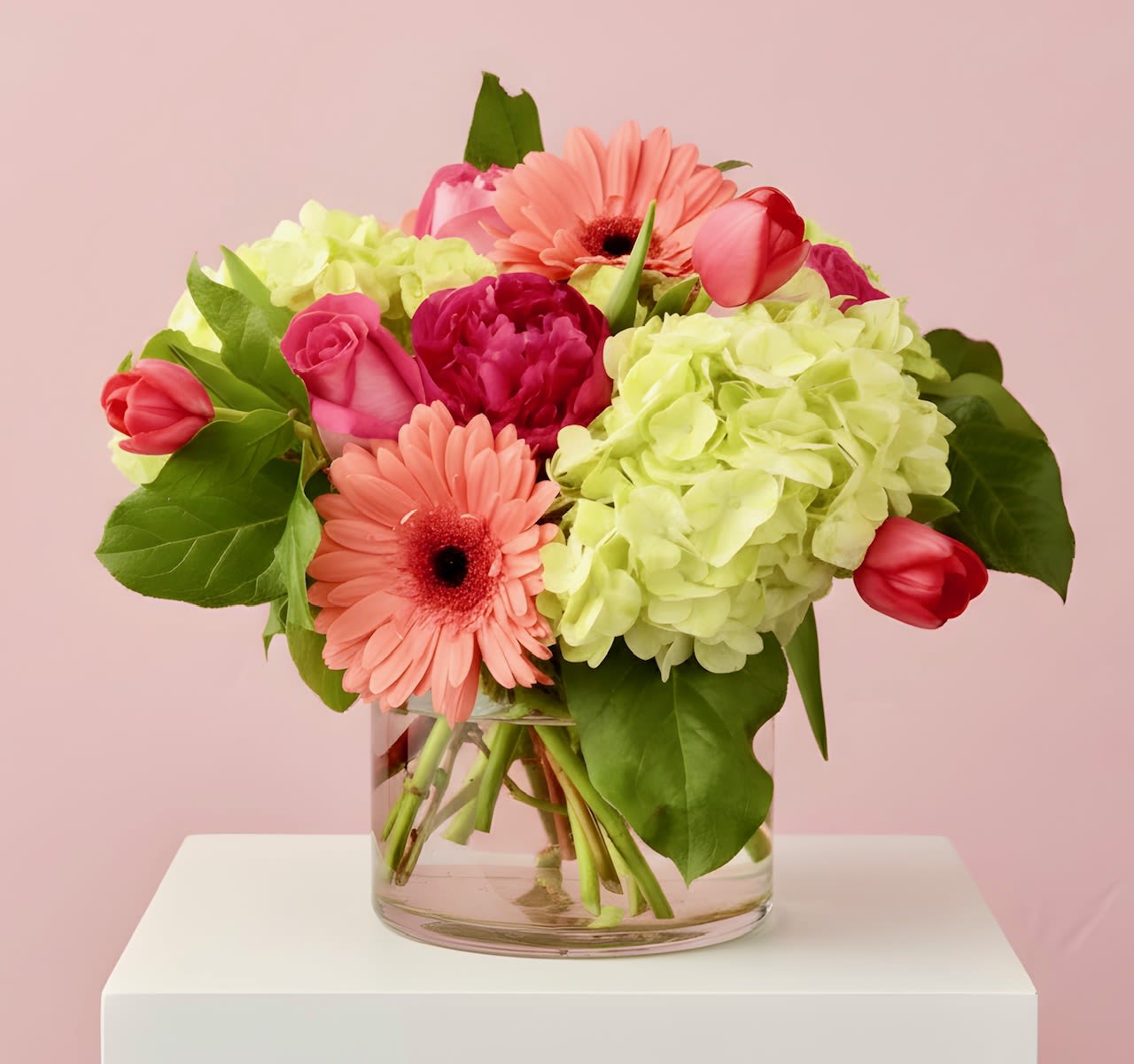 Pink and coral flowers in a clear glass vase