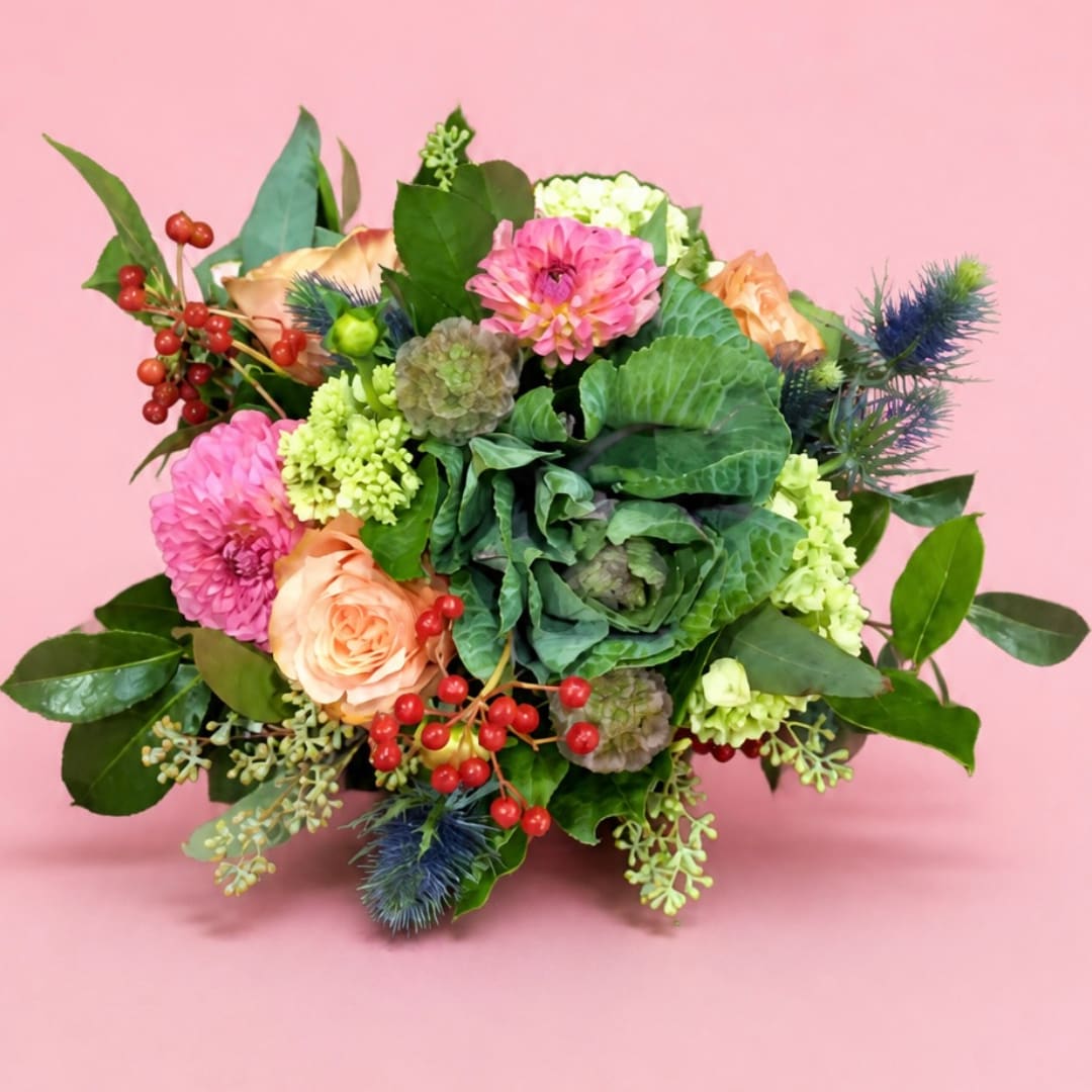 Mixed bouquet with pink and peach flowers on a pink background