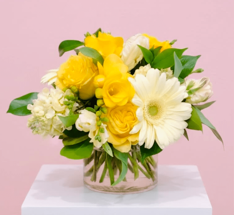 Mellow Yellow - Sunlit yellow roses and crisp white gerbera daisies give this flower arrangement an immediate lift - a cheerful birthday bouquet or thank-you gift that reads as bright, friendly, and effortlessly fresh. 