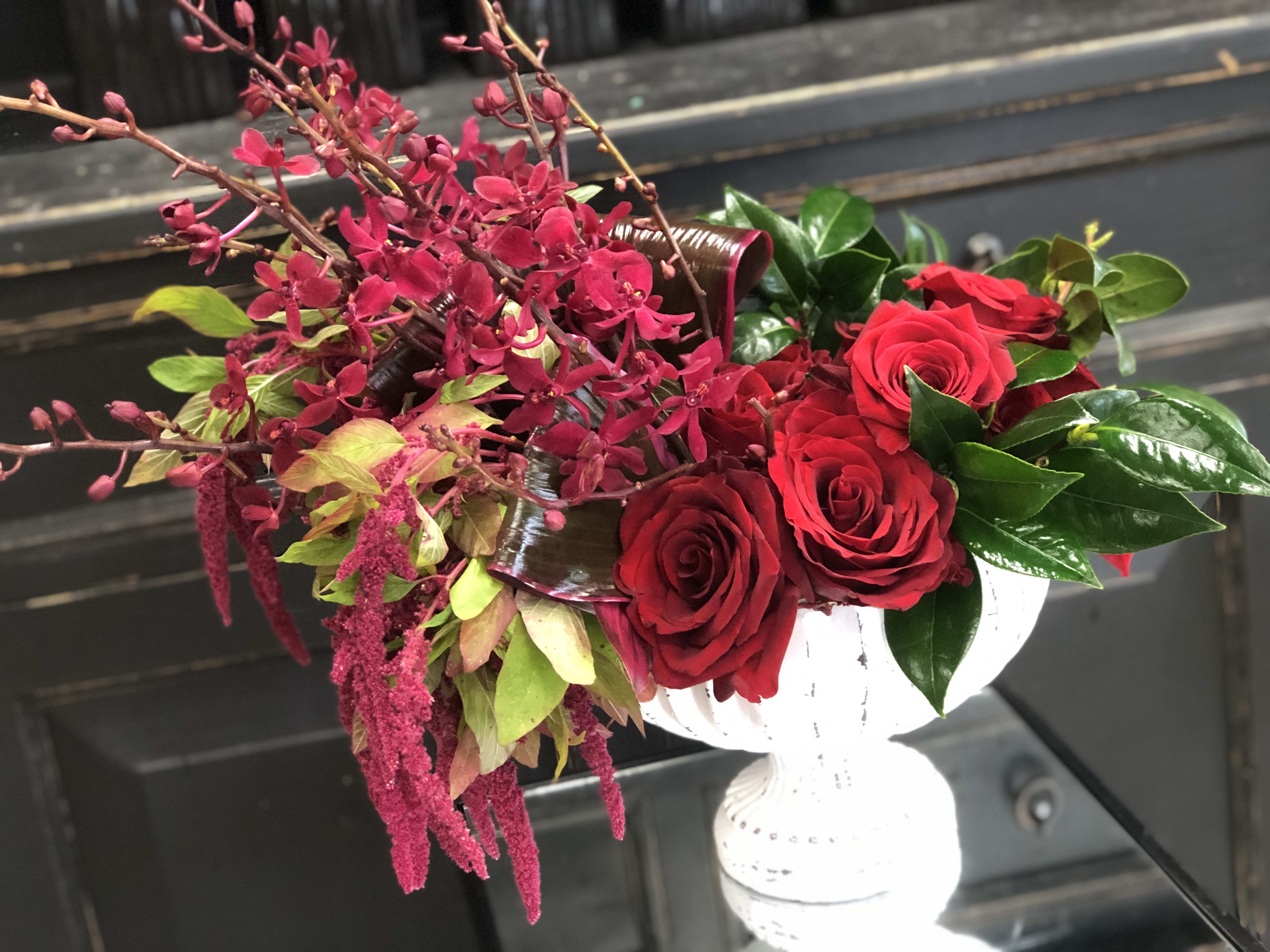 Romancing the Roses  - When rose meets orchid is love at first sight. Arranged in white clay urn, and beautiful textures with hanging red amaranthus, red orchids and roses. anniversary, Valentin's Day &amp; I love You.
