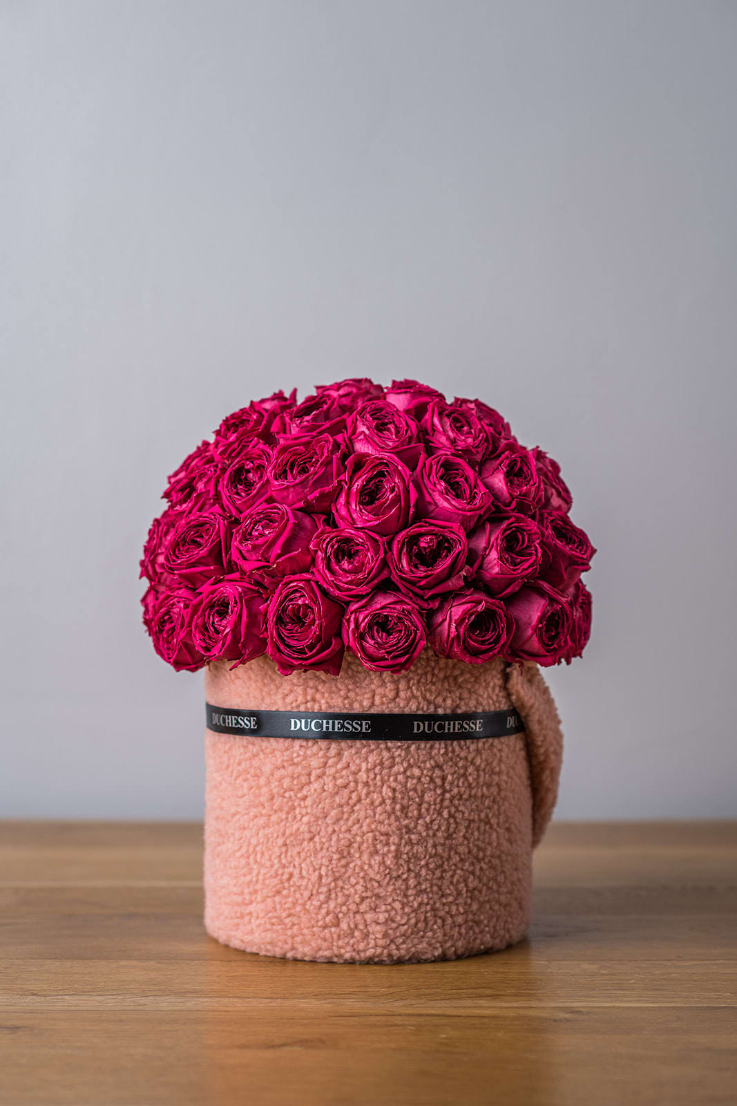 Hot pink rose arrangement in a textured blush hatbox