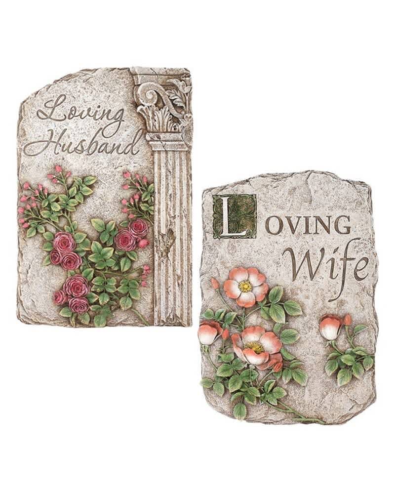 Two decorative memorial stones with floral relief and engraved names