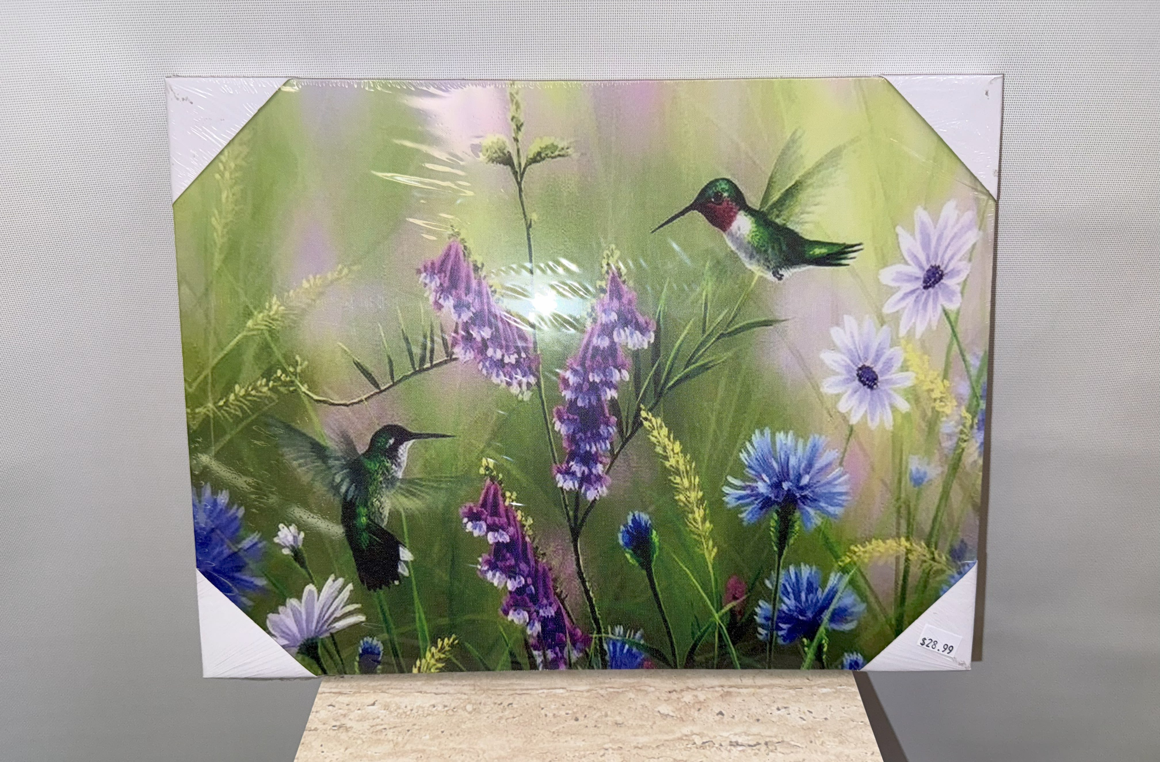 Decorative floral print with hummingbirds and purple-blue flowers