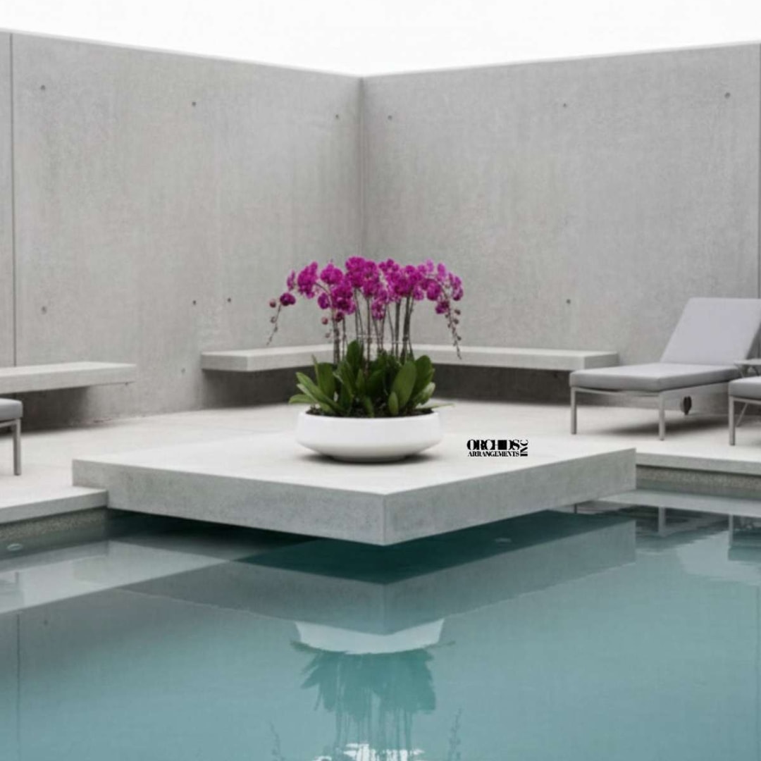 Purple orchids in a white bowl on a modern patio by a pool