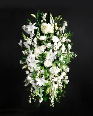 Tall white floral spray with lilies and mixed blooms